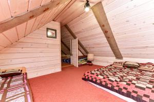 a bedroom with a bed in a attic at House in Krikstonys in Krikštonys