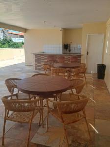 a group of tables and chairs in a room at Apto Praia do Meio in São José de Ribamar