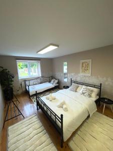 a bedroom with a large bed and a couch at Apartman Rooster in Srbobran