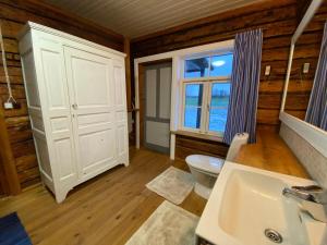 a bathroom with a toilet and a sink and a window at Farmhouseinn1923 in Tõhela +57 photos