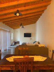 a living room with a bed and a table at las lavandas alojamiento in Tinogasta +3 photos