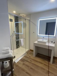 a bathroom with a sink and a glass shower at Château Morritt in Mont-Tremblant +46 photos