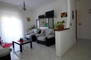 a living room with two couches and a tv at L Agrifoglio di Rita Loddo in Fonni