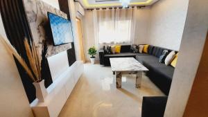a living room with a couch and a table at Azur et Atlas in Saïdia