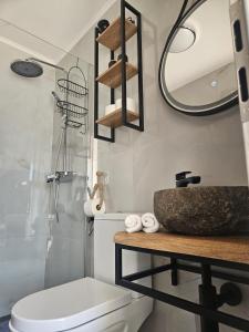 a bathroom with a toilet and a sink and a mirror at Apartment Lotta in Sali