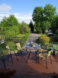 a table and chairs sitting on a patio at Agroturystyka Pod Podkową in Darłowo