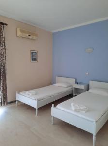 Postel nebo postele na pokoji v ubytování MARIA APARTMENTS