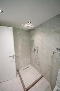 a bathroom with a shower with a hose in it at Endri Guest House  +34 photos