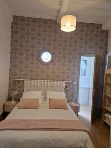 a bedroom with a large bed and a window at Les Fougères in Honfleur