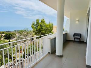 a balcony of a house with a chair on it at Althaia Hills - Precioso adosado con terraza panorámica al mar y montaña in Altea