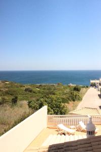 a view of the ocean from the balcony of a house at Sea View Suite with Pool - Praia da Luz in Luz