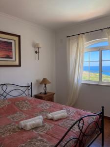 a bedroom with a bed with a view of the ocean at Sea View Suite with Pool - Praia da Luz in Luz