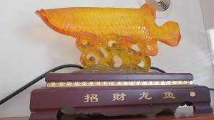 a gold fish statue sitting on top of a table at Chez Lilly in Oranjestad