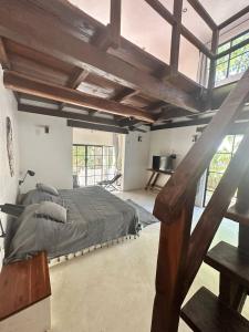 a bedroom with a large bed in a room with windows at Casa Mag-Ha in Francisco Uh May +24 photos