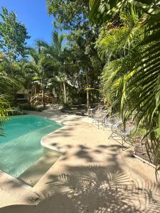 a swimming pool with chairs on a beach at Casa Mag-Ha in Francisco Uh May
