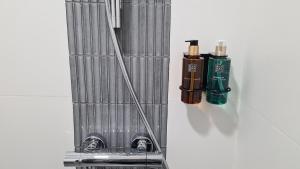a metal shelf with two bottles ofodorizers on it at Wezen in Vama Veche +30 photos
