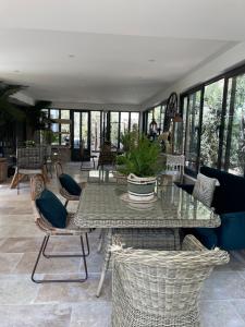 a dining room with a table and chairs and windows at Casa Di Lortu villa in Ajaccio