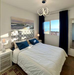 A bed or beds in a room at Beachfront Penthouse Apartment with Large Terrace and Breathtaking Sea Views close to Marbella Spain