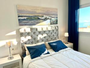 A bed or beds in a room at Beachfront Penthouse Apartment with Large Terrace and Breathtaking Sea Views close to Marbella Spain