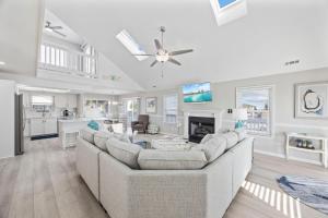 a living room with a large couch and a kitchen at Channel Surfer in Myrtle Beach