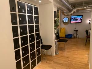 a room with a wall of wine racks at Svea Hostel in Stockholm