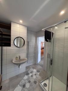 a bathroom with a sink and a shower at Gite Nathalie in Lièpvre