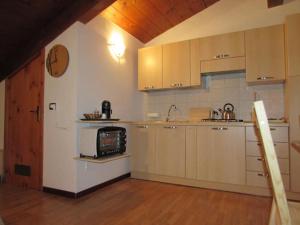 a kitchen with white cabinets and a microwave at centralatticmatera in Matera
