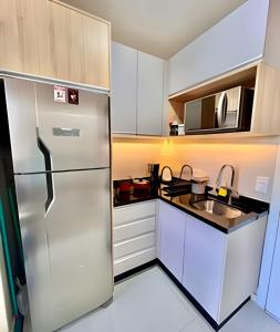 a kitchen with a refrigerator and a sink at FANTASTiCO, Apto 1 quarto c/ TvSmart e Ar Cond. in Curitiba