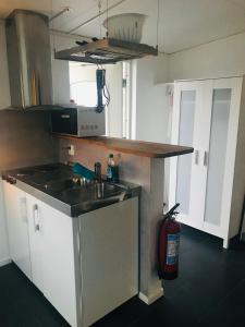 a kitchen with a sink and a stove at Kungsgatan 36 in Borgholm