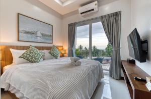 Postel nebo postele na pokoji v ubytování Surisa Seaview Pool Villas