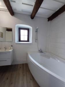 a white bathroom with a tub and a sink at Cottage Amelia in Čechy +24 photos