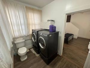 a bathroom with a washing machine and a toilet at 2BR 1st floor suite close to ISU in Terre Haute +27 photos