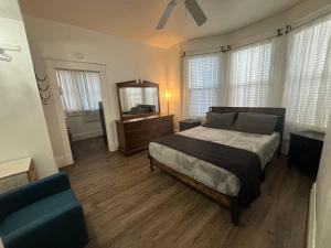 a bedroom with a large bed and a mirror at 2BR 1st floor suite close to ISU in Terre Haute