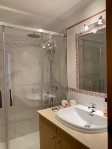 a bathroom with a sink and a shower at El Rincón de Naya in Portonovo +21 photos