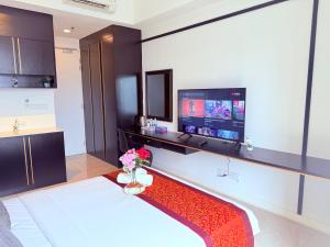 a room with a bed and a flat screen tv at Luxury Axon Suites KLCC-PAVILION in Kuala Lumpur