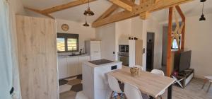 a kitchen with a wooden table and a dining room at Chalet in Le Teich