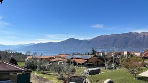 a town with a view of the water and mountains at Luisa Apartment, Lake Maggiore in Brezzo