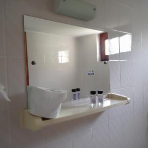 a bathroom with a sink and a mirror at Asprovalta Rooms in Kariotes +36 photos