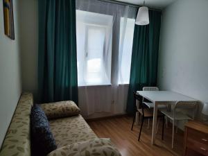 a room with a table and a couch and a window at The Small Nest in Vienna