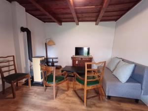a living room with a table and chairs and a couch at Cottage Amelia in Čechy