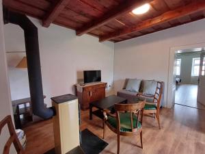 a living room with a couch and a table at Cottage Amelia in Čechy