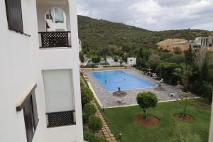 an external view of a building with a swimming pool at Sea View Apartment in Cabo Negro