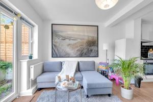 a living room with a couch and a table at The Connected Garden Flat - Parking, Work & Play, 3x in Colindale +20 photos