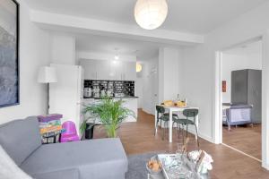 a living room and kitchen with a couch and a table at The Connected Garden Flat - Parking, Work & Play, 3x in Colindale