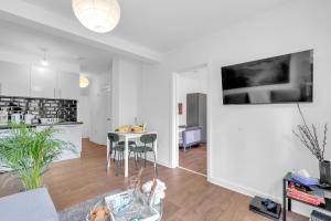 a kitchen and living room with a table and chairs at The Connected Garden Flat - Parking, Work & Play, 3x in Colindale