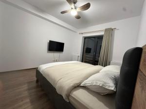 a bedroom with a bed and a ceiling fan at Busteniview in Buşteni +14 photos