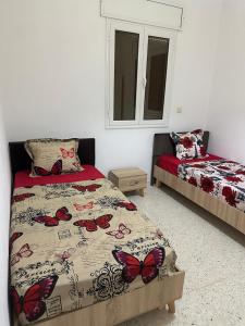 Postel nebo postele na pokoji v ubytování Résidence Zohra