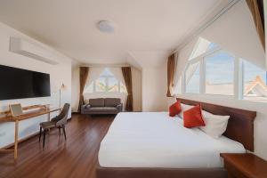 une chambre avec un lit, un bureau et une télévision dans l'établissement บ้านทะเลสำราญ by May, à Cha Am 21 autres photos