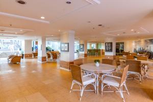 a lobby with tables and chairs in a building at Ozped Private Flats Manhatan in Brasília