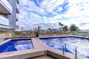 a swimming pool on the roof of a building at Ozped Private Flats Manhatan in Brasília